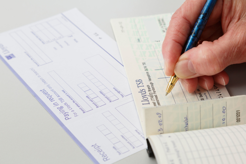 Writing Checks | Alamy Stock Photo by PearlBucknall