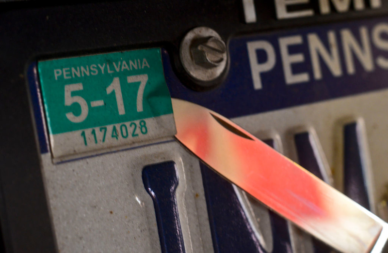 Use Dampened Newspaper to Remove Old Registration Stickers | Getty Images Photo by Jeremy Drey/MediaNews Group/Reading Eagle